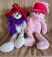 Both teddy bears seated side by side