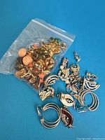 All jewellery laid out showing earrings, pendants, bag of beads