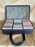 Open carrying case showing all cassette tapes