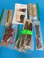 Overview of all packaged watch bands showing variety of materials and colors