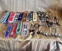 Overall view showing packaged and loose souvenir spoons