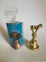 Both bells side by side, one boxed, one unboxed