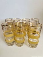 Group of ten clear glass tumblers with gold bands