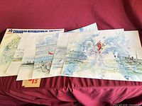 All six prints partially spread with portfolio sleeve visible