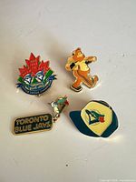 Front view of four Toronto Blue Jays enamel pins