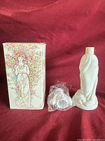 Bottle, box and sealed stopper displayed