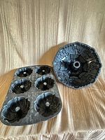 Large carousel Bundt pan and six-cavity mini Bundt pan side by side