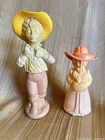Front view of both Avon figurine decanters