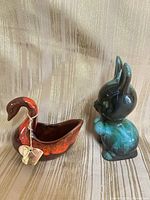 Both pottery figurines side by side showing scale and color