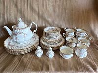 Full set showing teapot, plate stacks, shakers, cups
