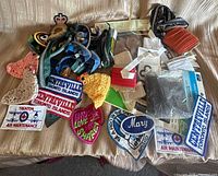 Overall view of entire lot on sofa showing patches, zippers, packaged notions