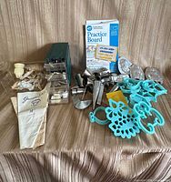 full lot overview showing tips organizer, piping bags, practice board, cutters, candy molds