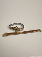 Watch and spare band on plain background