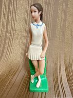 Front view of Wilton plastic tennis player cake topper