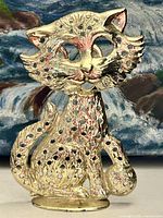 Front view of brass cat earring holder