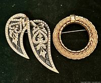 Front view of both brooches showing designs, stones and enamel