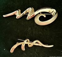 front view of both brooches showing design and size relation
