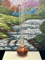 Full view of vase against background painting