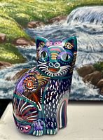 Front view of multicolored hand-painted ceramic cat figurine