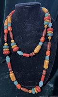 Full view of long multi-strand necklace on bust