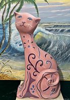 Front view of ceramic cat bank showing painted design