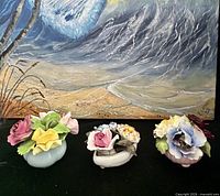 All three bone china floral posies grouped in front of painting
