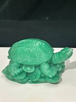 Side view of green jade turtle on wave base