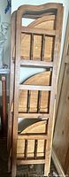 Etagere folded flat showing hinged triangular shelves and frame