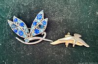 Front view leaf rhinestone brooch and gold-tone bird brooch