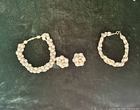 Full set: two bracelets and pair clip-on earrings on green background