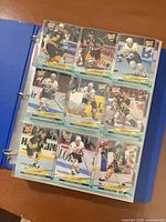 Page of nine Fleer Ultra hockey cards visible in binder