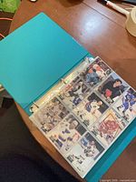 Open binder showing pages of 9-pocket sleeves filled with hockey cards