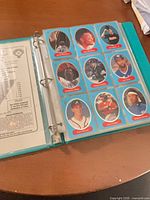 Binder open showing nine Upper Deck cards with blue borders in plastic page