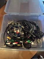 Top view of plastic box filled with assorted cables