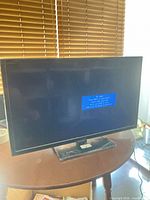 Front view of Insignia TV powered on showing “No Signal” message