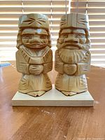 Both figurines on display base