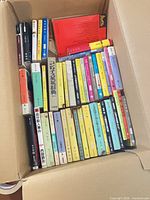 Top view of open box showing full assortment of Japanese paperback books neatly lined