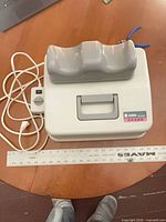 Top view of massager showing cradle, handle, power cord and external dial.