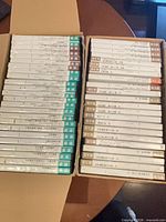 Two open boxes showing rows of slim jewel-case DVD-R discs with Japanese labels