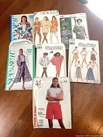 Group shot of all eight sewing pattern envelopes spread on table