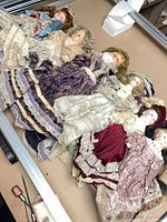 Seven dolls laid out showing overall lot