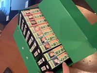 Open green case showing nine VHS spines numbered