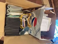 Top view of cardboard box with stacks of jewel cases, sleeves and loose discs