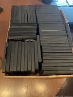 Box filled with rows of black DVD cases