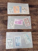 Three glassine envelopes containing a total of ten unused international stamps