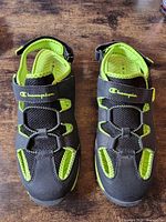 Top view of both sandals showing Champion logo, mesh uppers, hook-and-loop instep straps, and color details