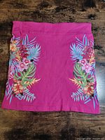 Front view of fuchsia skirt showing tropical print panels