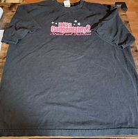 Full front view of black Miss Congeniality 2 T-shirt laid flat