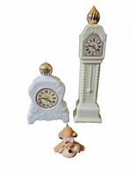 Front view of both Avon clock bottles and Russ Berrie dog figurine