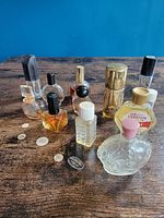 Group shot of all nine vintage perfume bottles on table